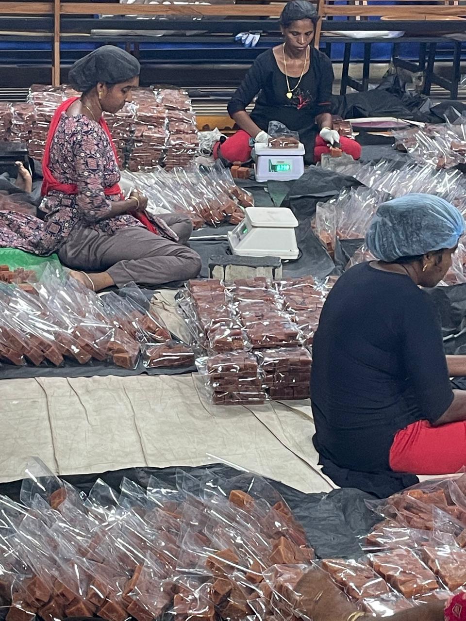 Bagged jaggery cubes checked on digital scales