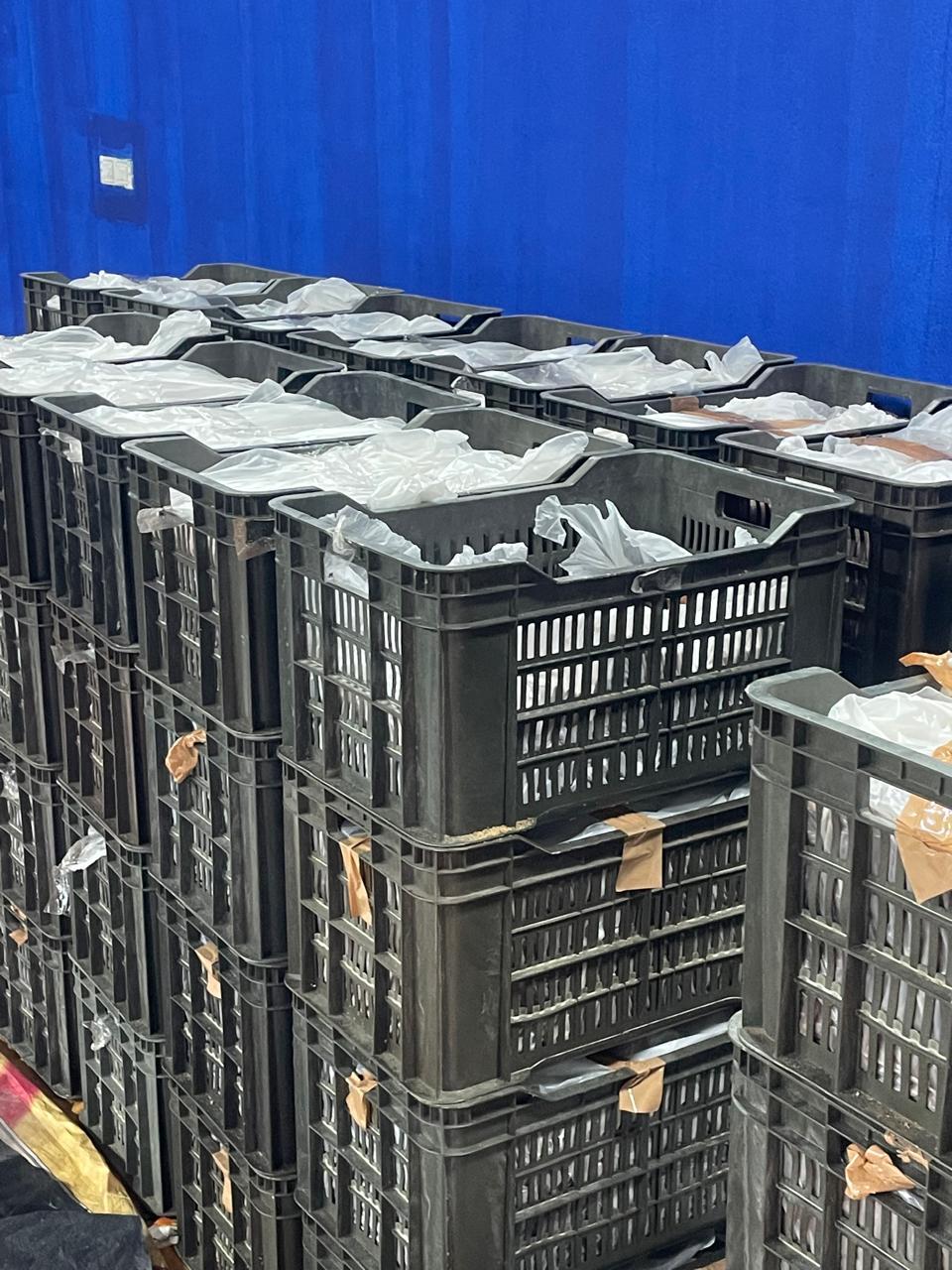 Plastic-lined crates of jaggery staged for packing and shipment