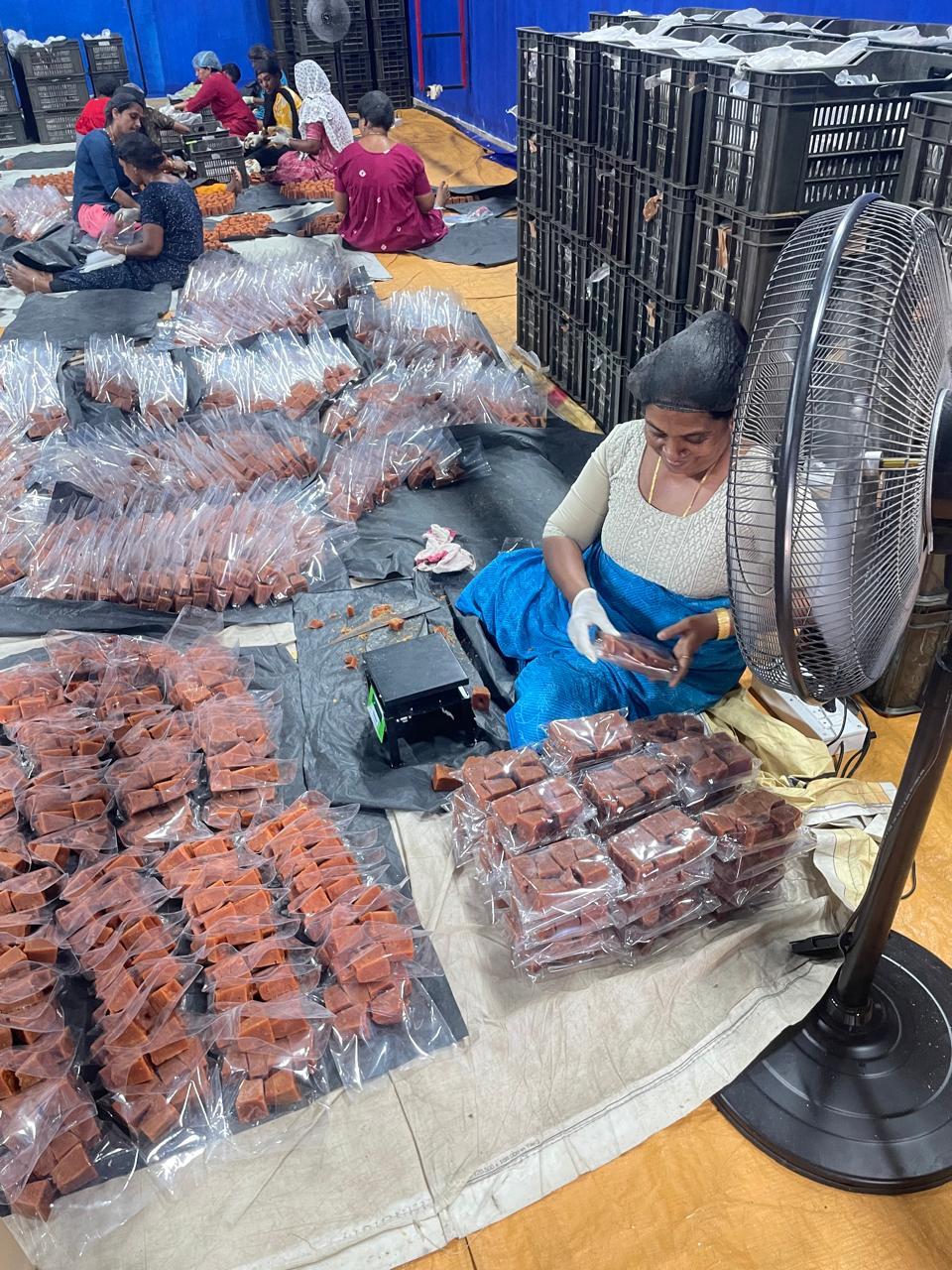 Portion weighing station for jaggery cubes