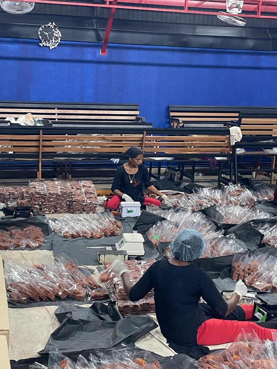 Digital weighing of jaggery cubes into clear export packs