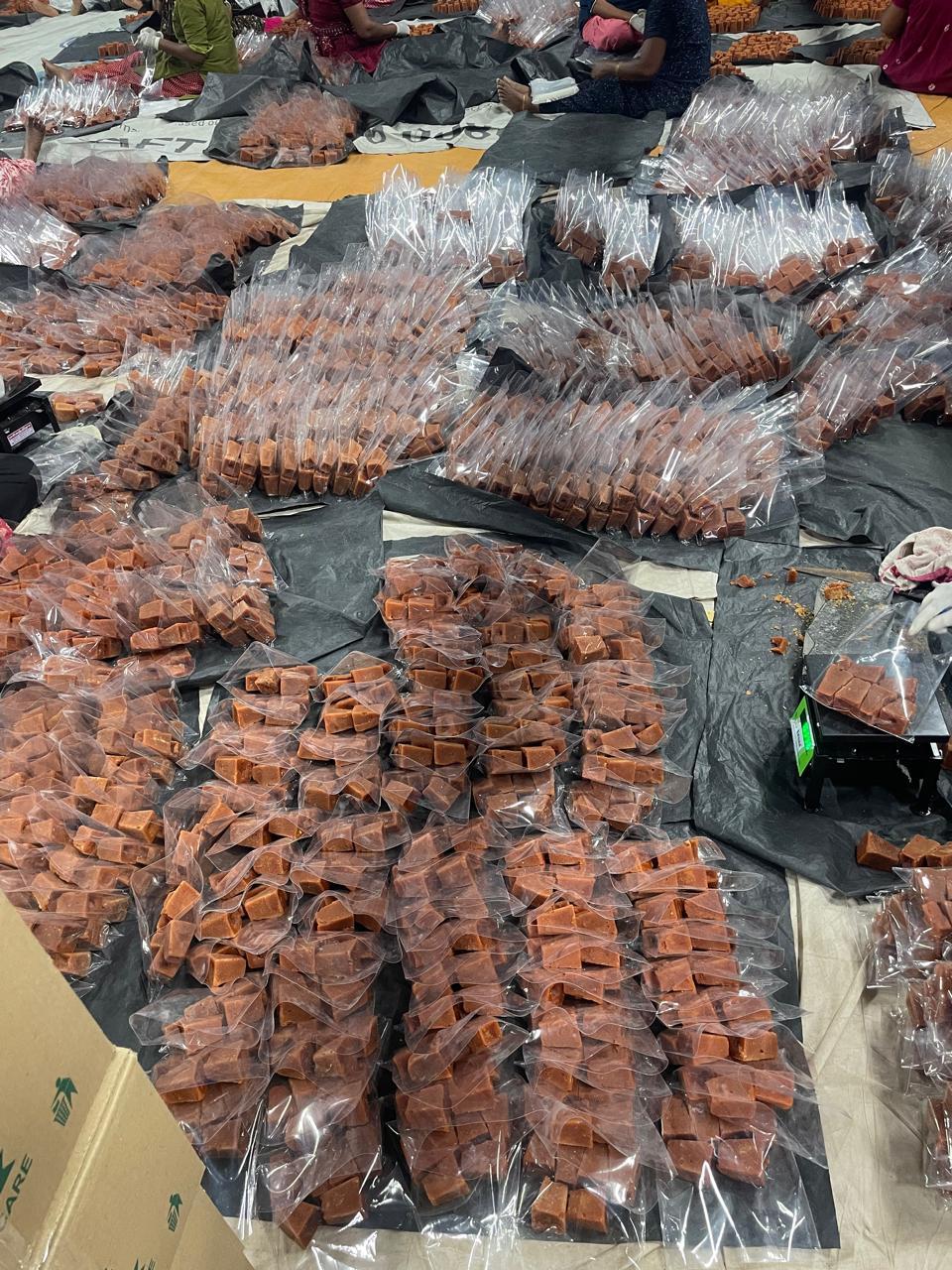 Rows of weighed jaggery bags prepared for cartoning